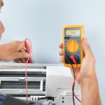 Portrait,Of,A,Mid-adult,Male,Technician,Testing,Air,Conditioner,With