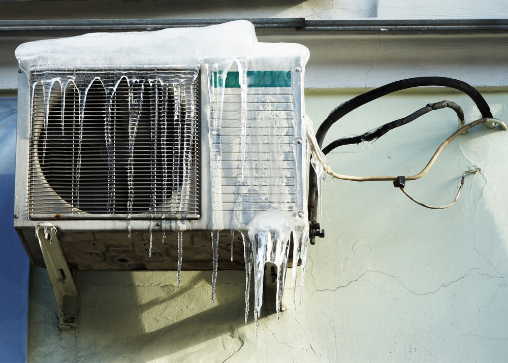 The,Conditioner,Covered,With,Icicles,On,A,Yellow,Wall