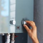 Close-up,Of,Male,Hand,Adjusting,Temperature,Of,Water,Heater.,Modern