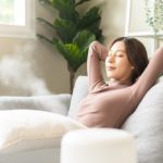 Modern,Air,Humidifier,During,Relax,Or,Rest,,Happy,Asian,Young