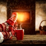 Woman,Legs,With,Christmas,Socks,And,Home,Interior,With,Fireplace